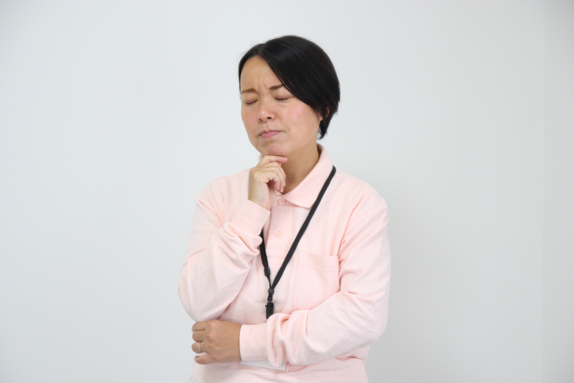 悩む作業着姿の女性