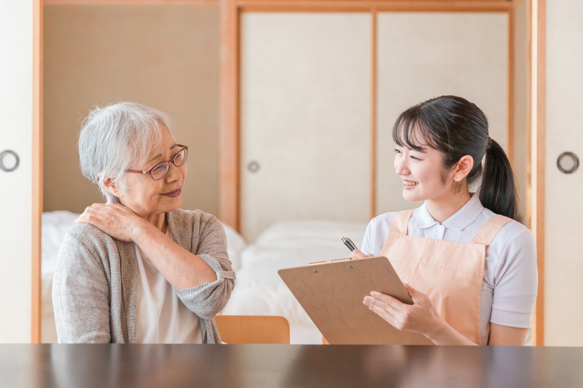 和室にいる介護スタッフと高齢者