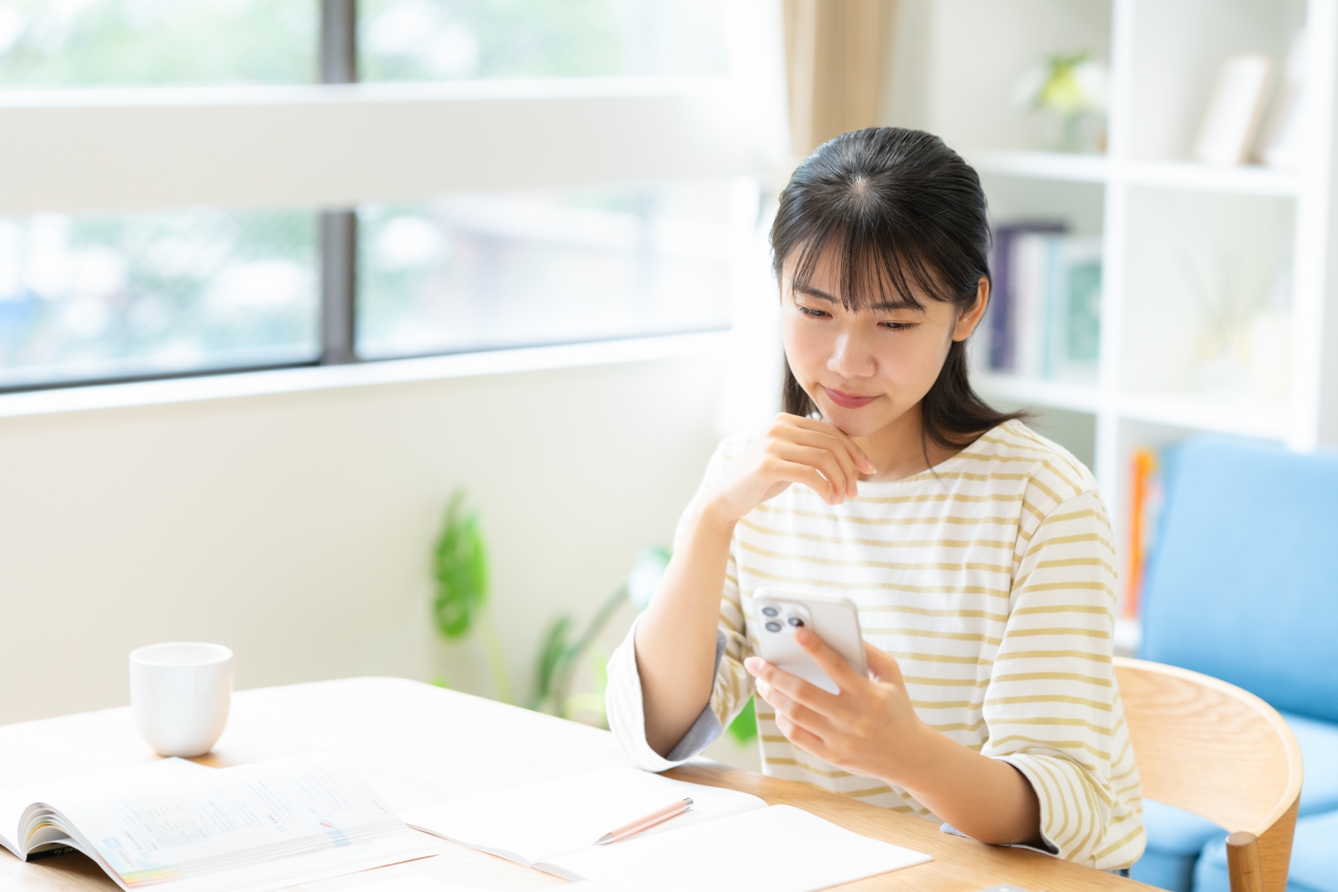 リビングで勉強をする大学生の女性
