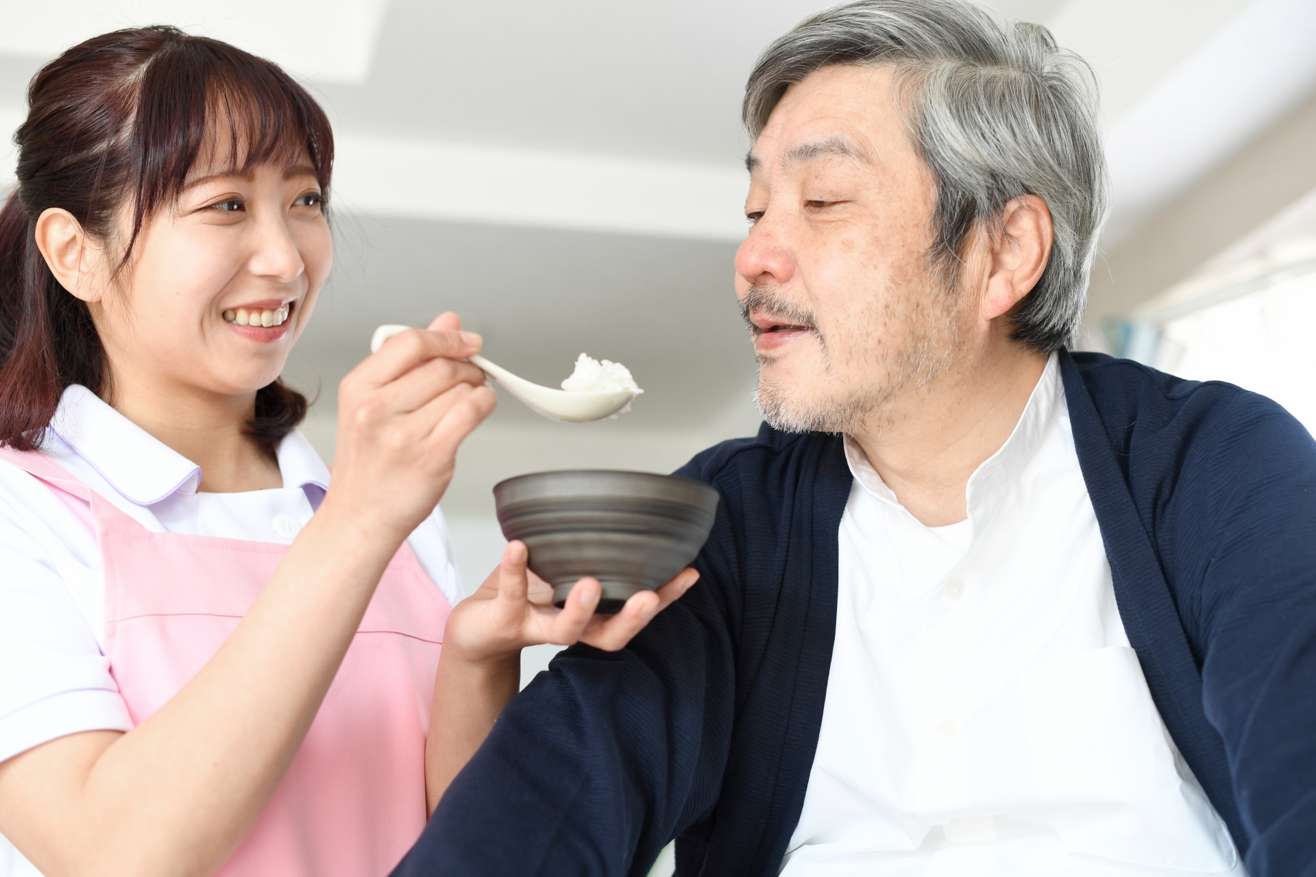 食事介助を受ける男性