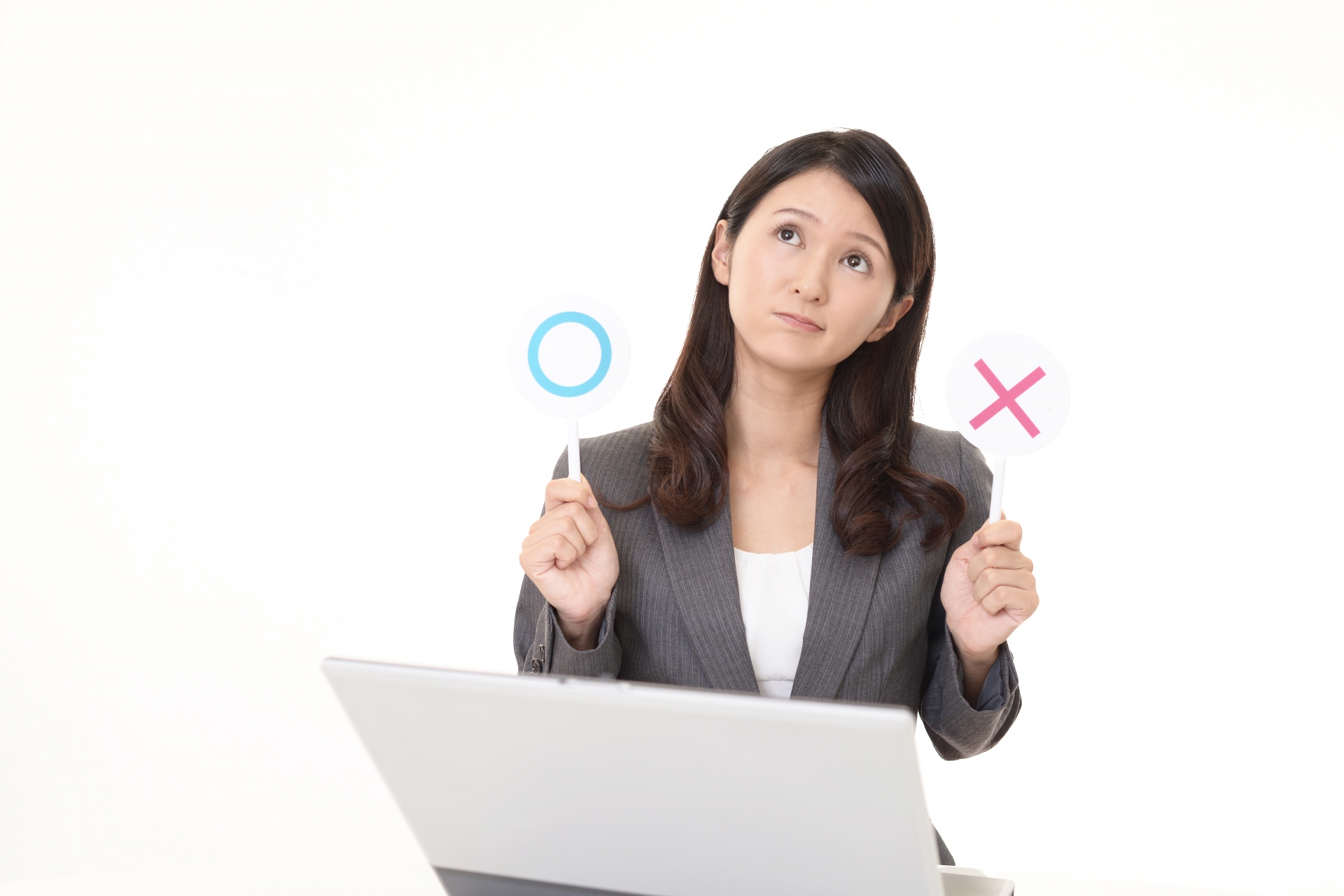 丸とバツを手に持つ女性