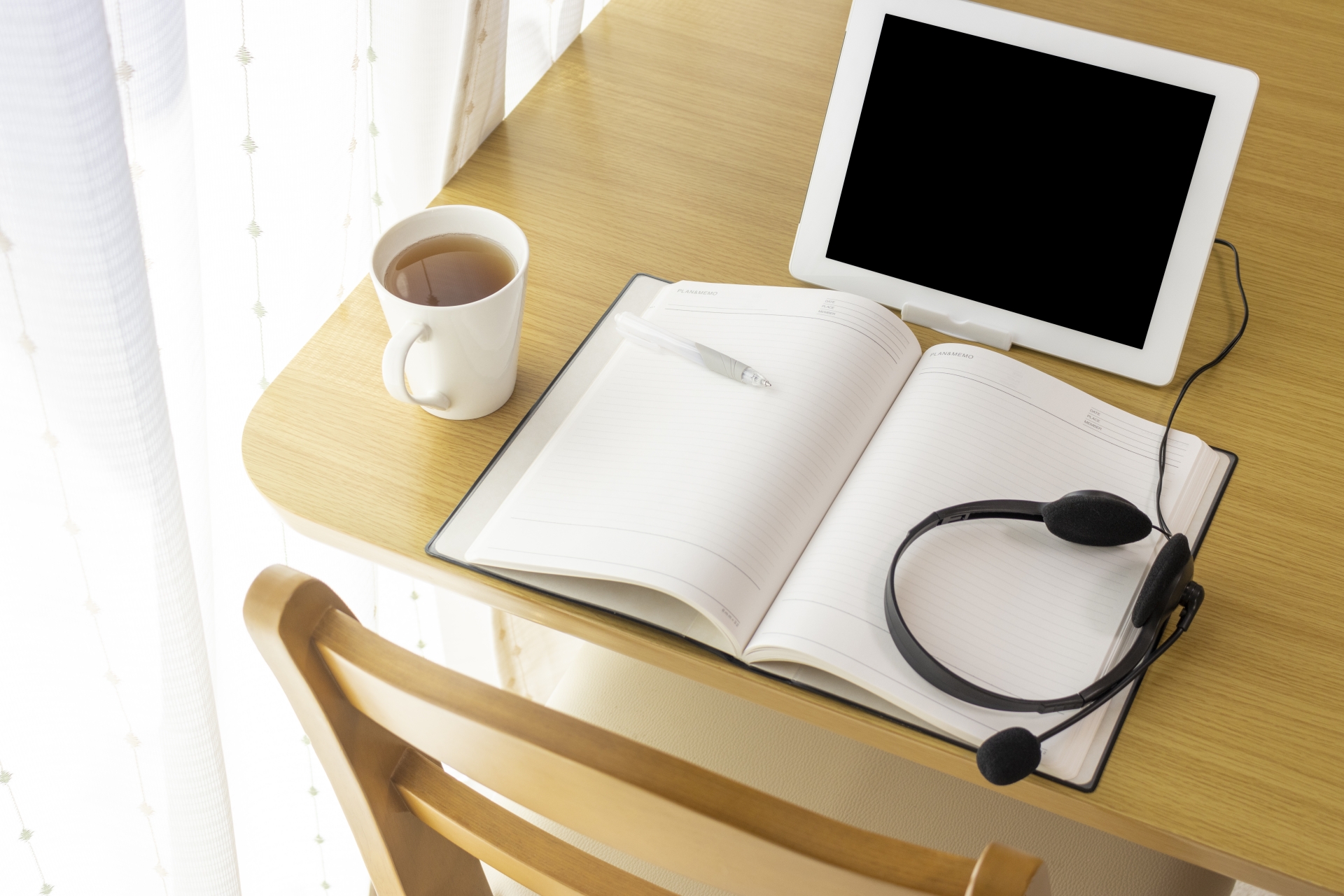机の上のタブレットとノート