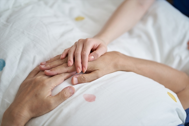 最後を看取られるアジア人の高齢者の手元