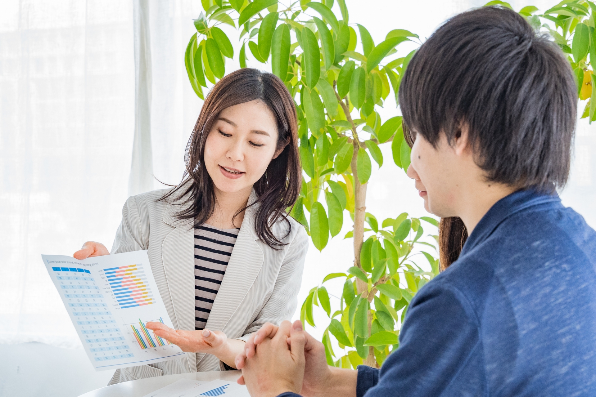 資料を見せて説明する女性
