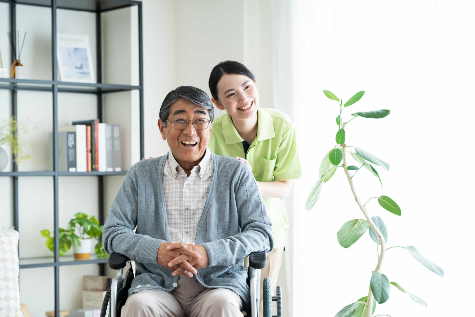 車椅子のシニアの男性と介護福祉士