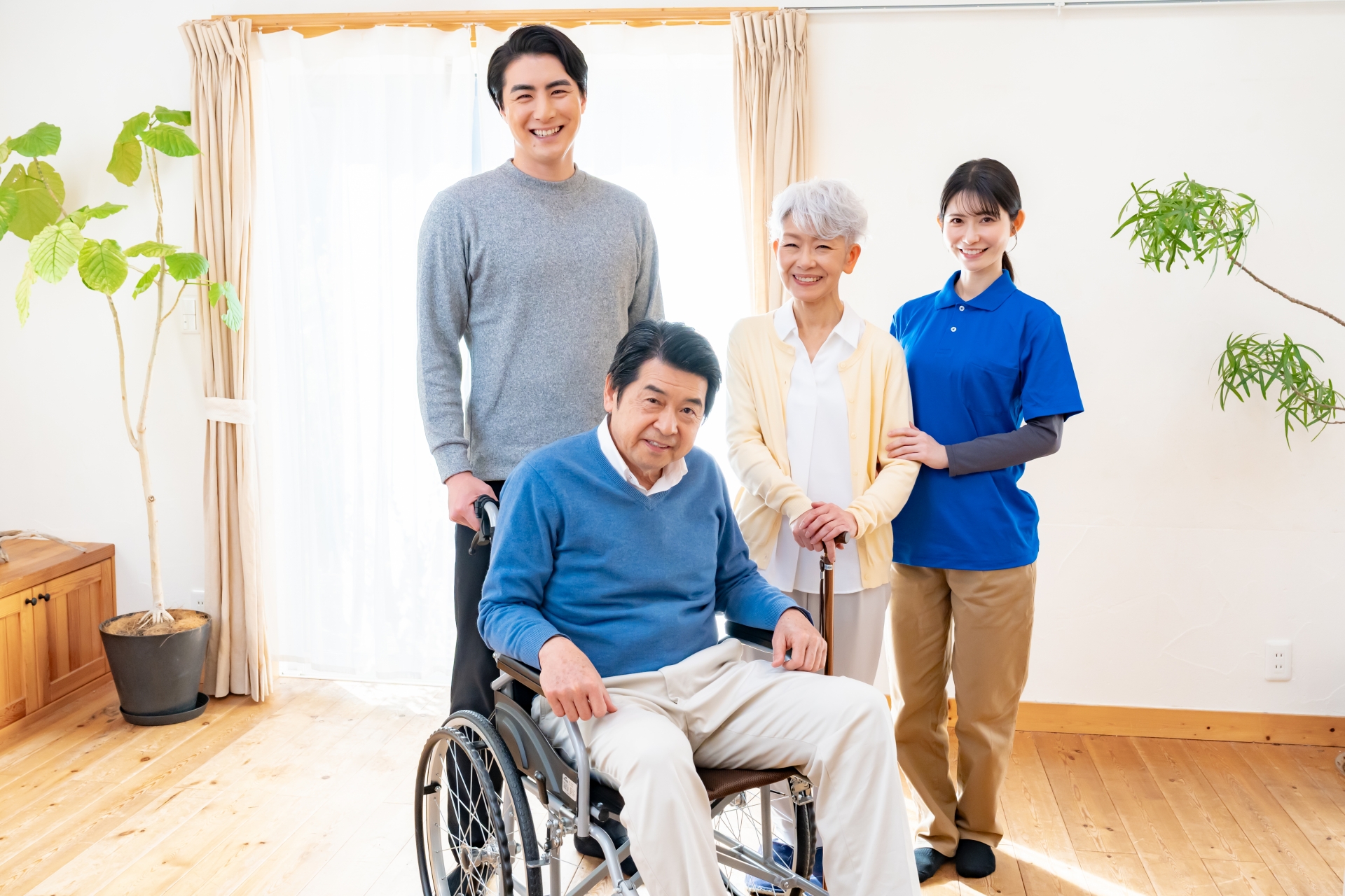 車椅子の男性と家族と介護スタッフ