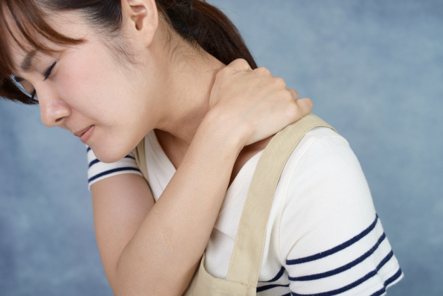 肩こりが辛そうな女性