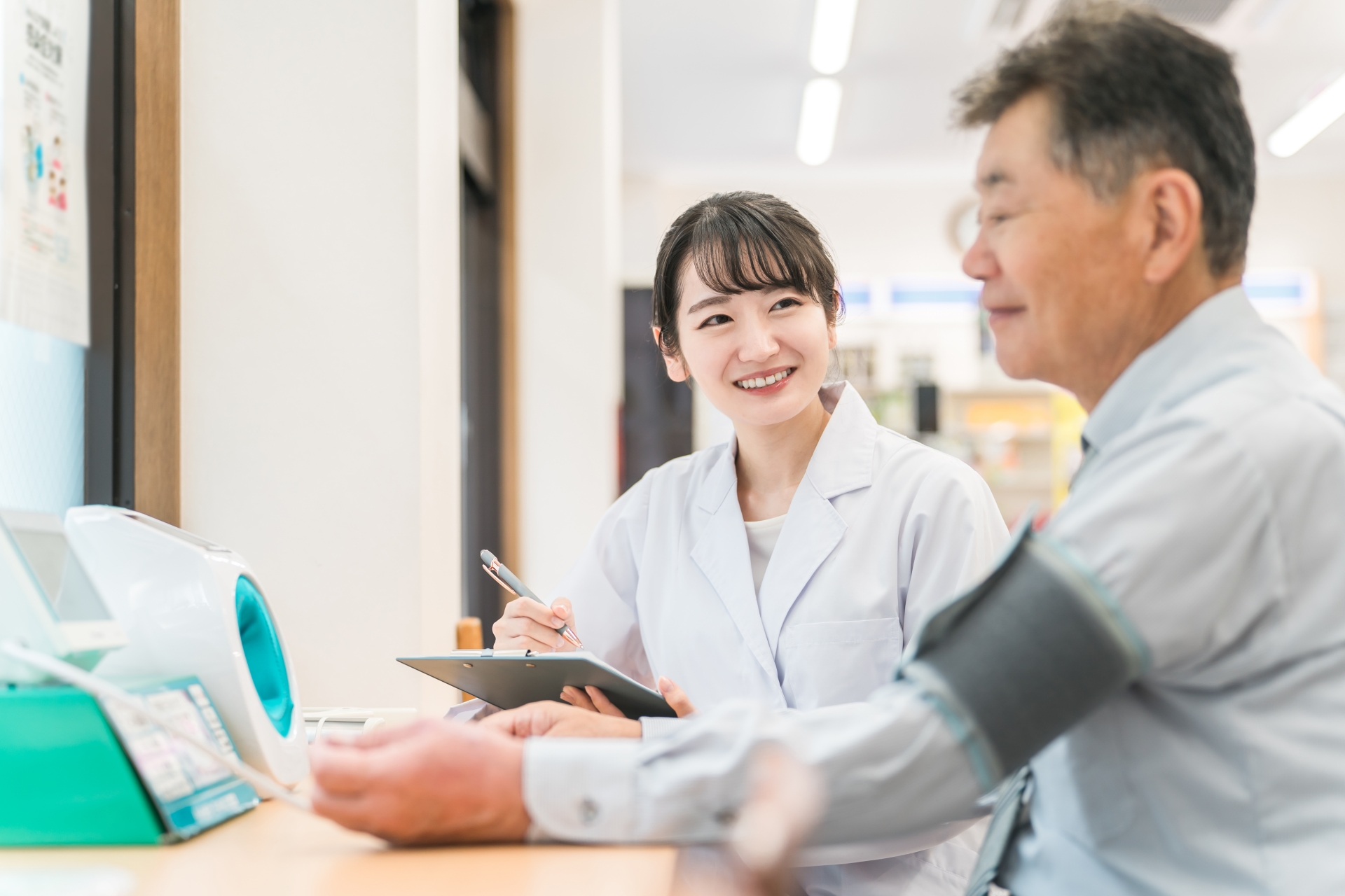 病院で健康診断する男性と医師（血圧）