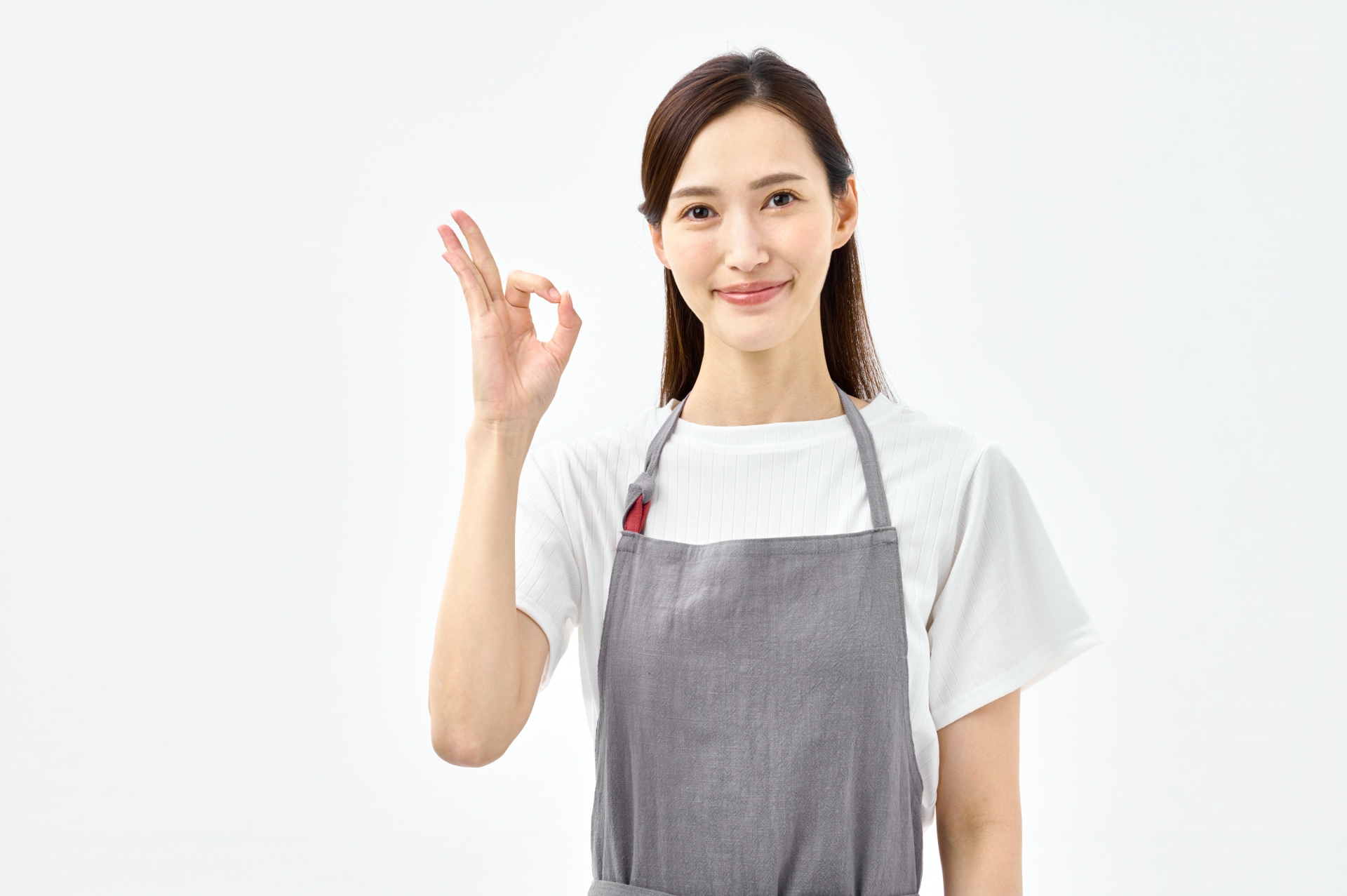 OKポーズをするエプロンの女性