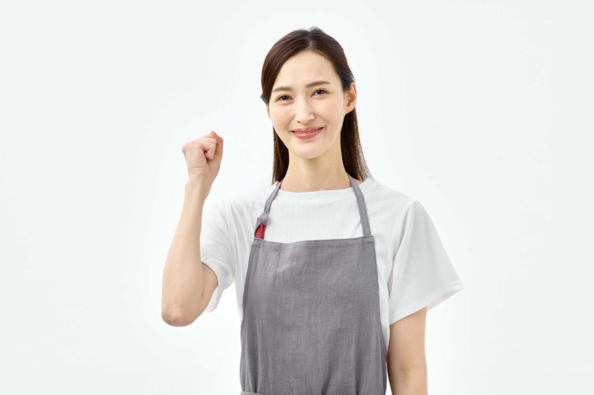 ガッツポーズするエプロンの女性